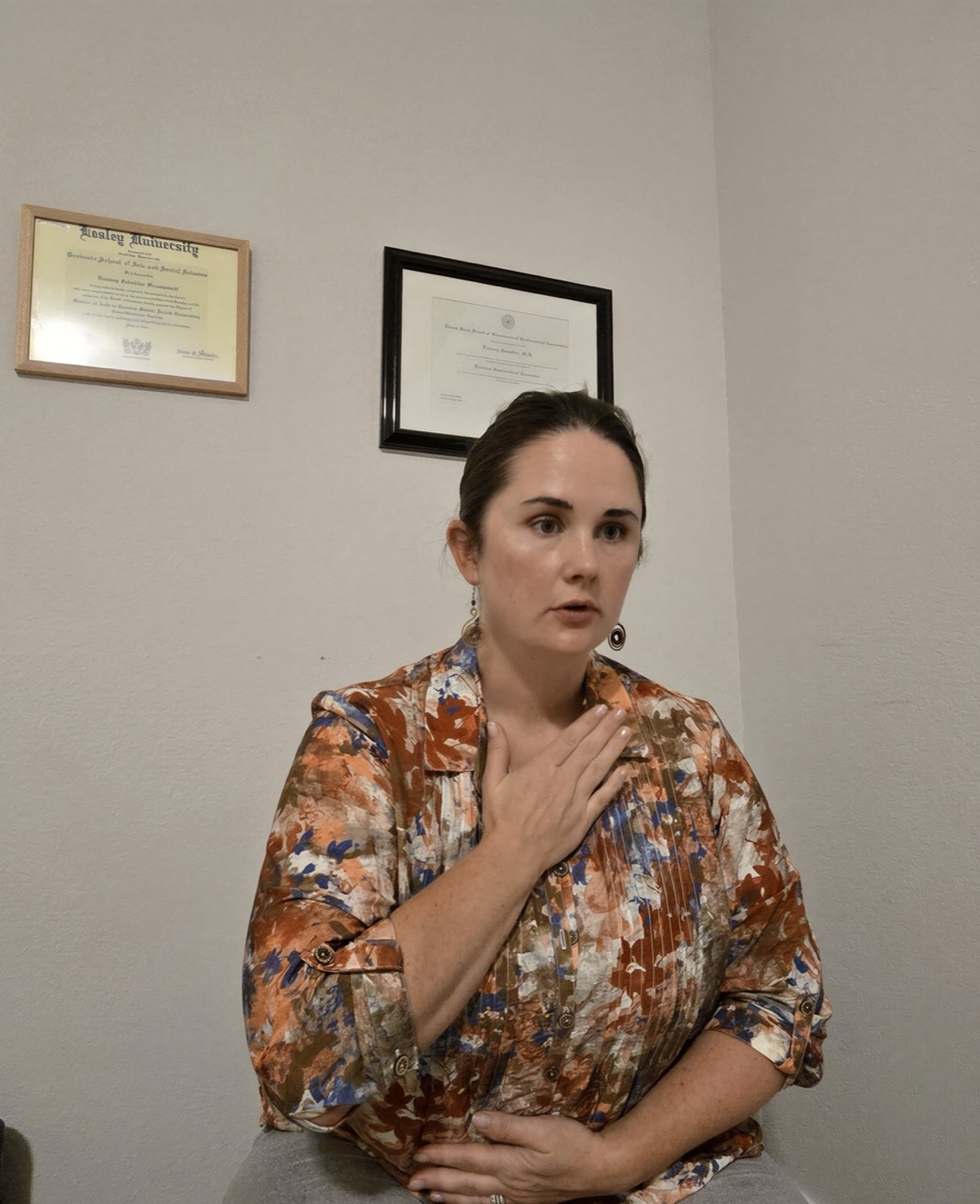 Destany Schadder speaking with a client in her Austin, TX office